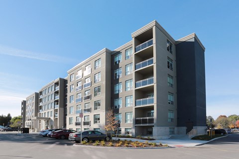 a large apartment building with a parking lot in front of it