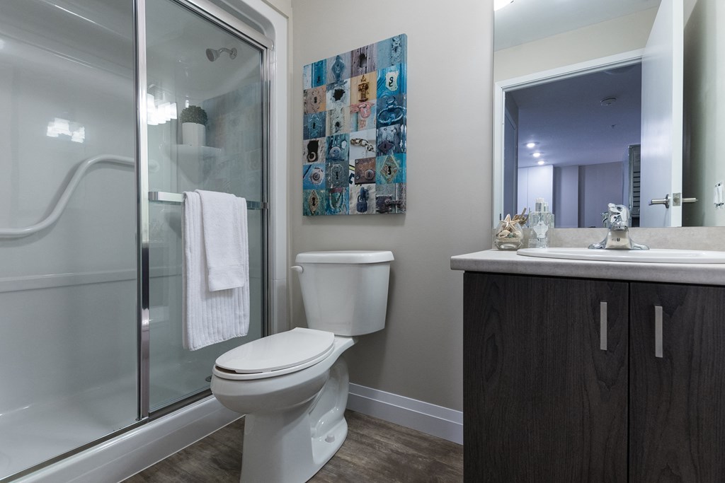 a bathroom with a toilet sink and shower