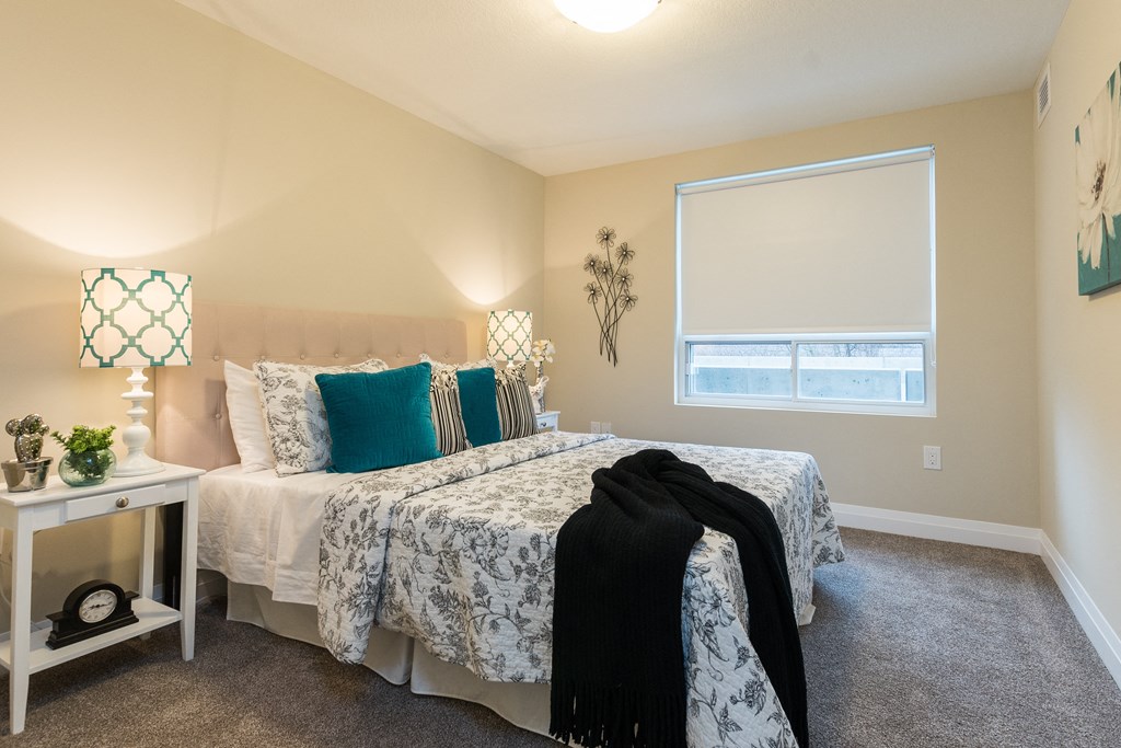 a bedroom with a bed and a window