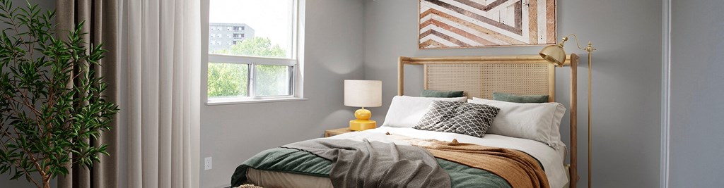 a bedroom with a bed and two windows