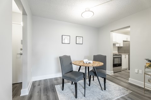 A dining room with a round table and chairs  at Platts Crossing, London, ON, N6H 4P4