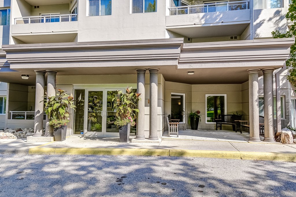 the facade of a building with columns and a patio