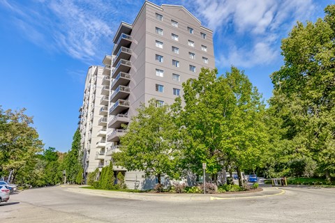 an empty street with an apartment building in the background