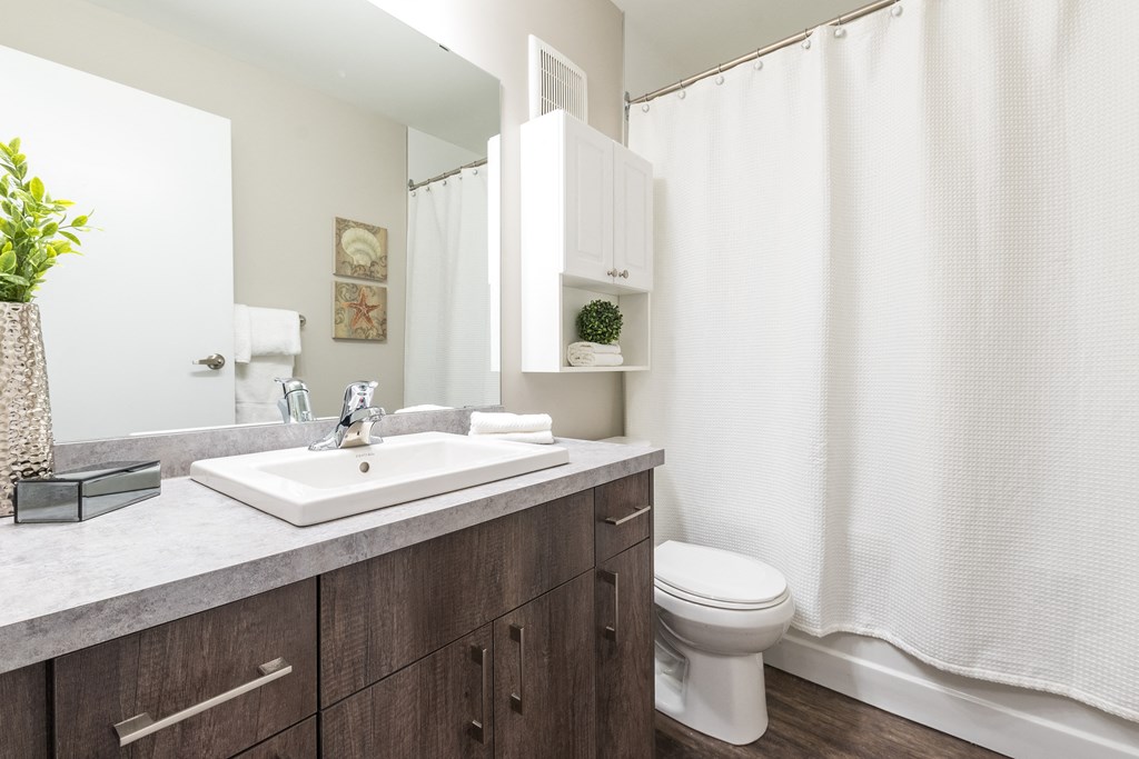 a bathroom with white walls and a white shower curtain