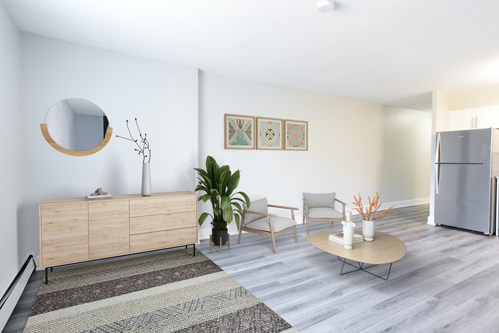 a living room with a refrigerator and a table