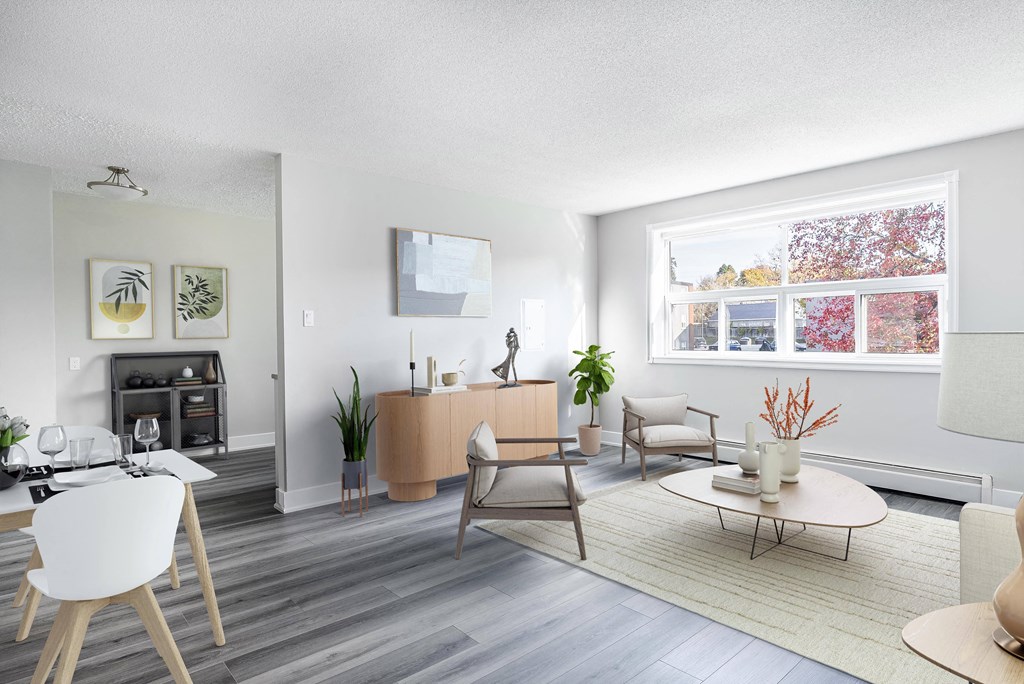 A living room with a fireplace and a large window.