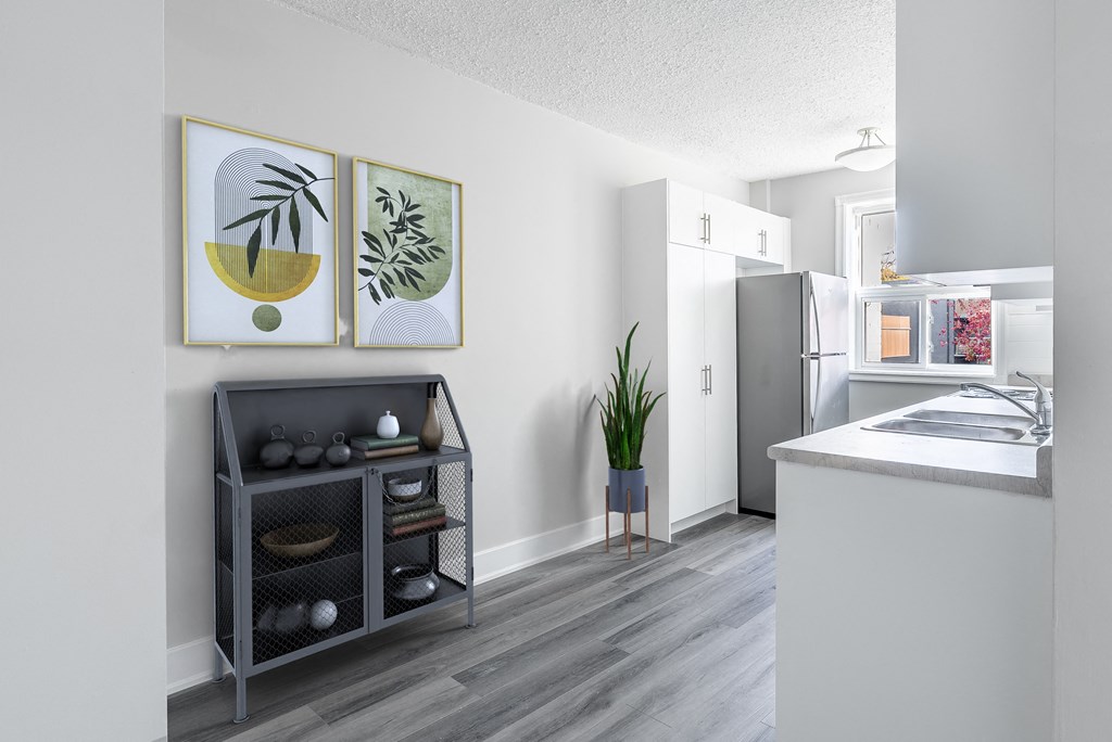 A kitchen with a grey cabinet and a white counter.