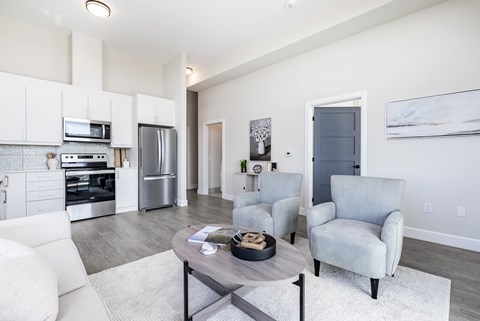 A modern kitchen with white cabinets and stainless steel appliances.