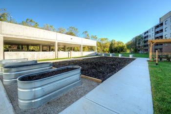 Community garden with metal planters and grass  at Platts Crossing, London, ON, N6H 4P4