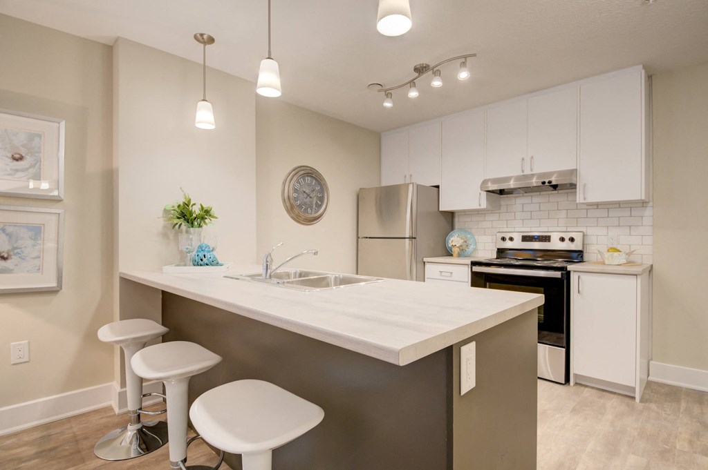 Kitchen with white cabinets and an island.