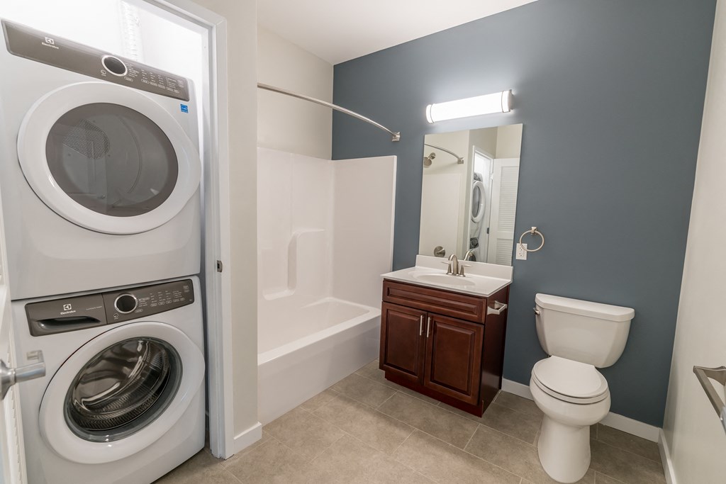 a bathroom with a washer and dryer in it