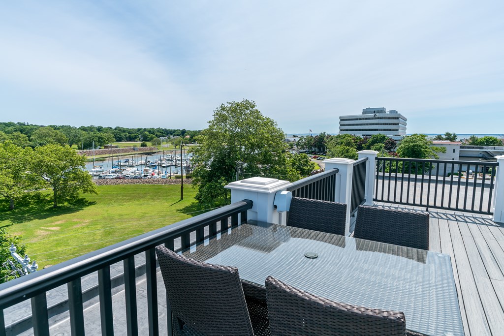 large deck off the living room with dining table and chairs