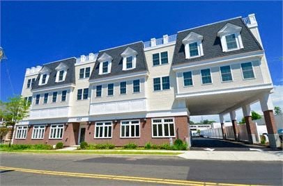 a large white building with a gray roof