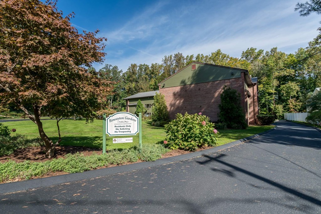 a building with a sign on the side of a road
