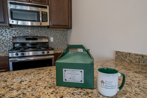 a cup of coffee and a box of tissues on a kitchen counter