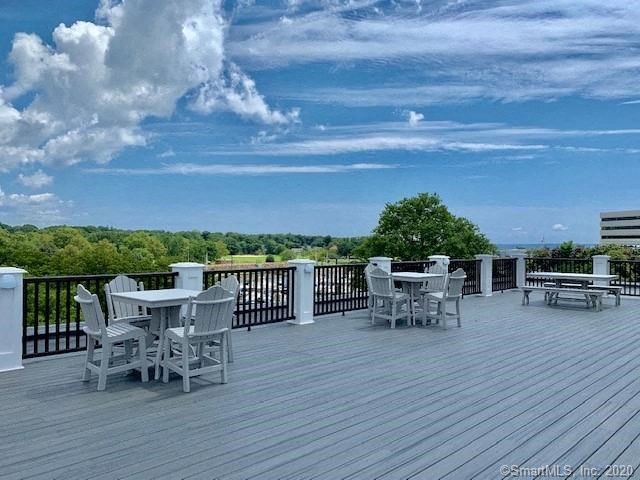 a large deck with tables and chairs on it