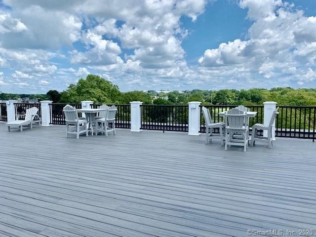 a deck with a table and chairs on it