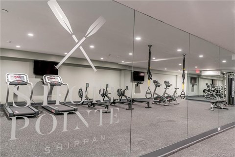 a gym with treadmills and other exercise equipment