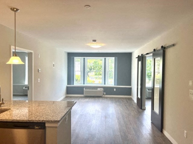 an empty living room with a large window