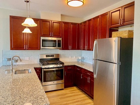 a kitchen with granite counter tops and stainless steel appliances