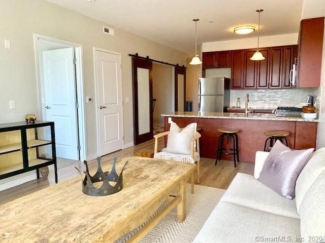 a living room filled with furniture and a wooden table