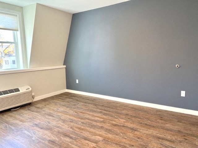 an empty room with a radiator and a window