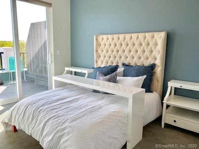 a bedroom with a bed and a sliding glass door