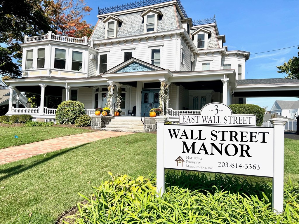 a large white house with a sign that reads wall street manor