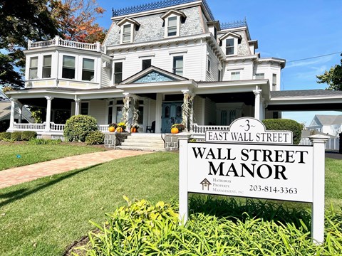 a large white house with a sign that reads wall street manor