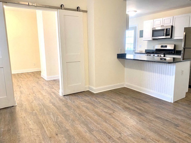 an empty room with a kitchen and a counter