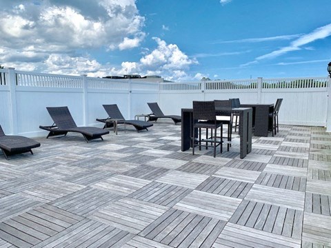a patio with a table and chairs on it