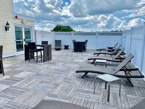 a patio with a bunch of chairs on it