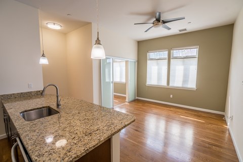 a kitchen with a sink and a ceiling fan