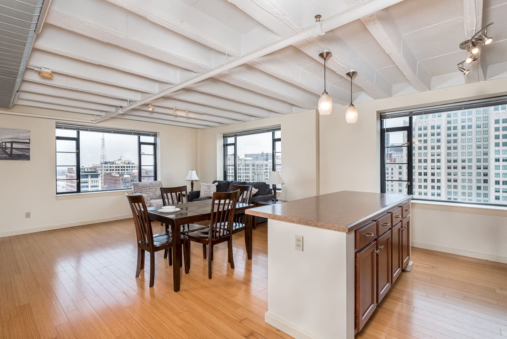 a kitchen and dining area with a table and chairs and a large window