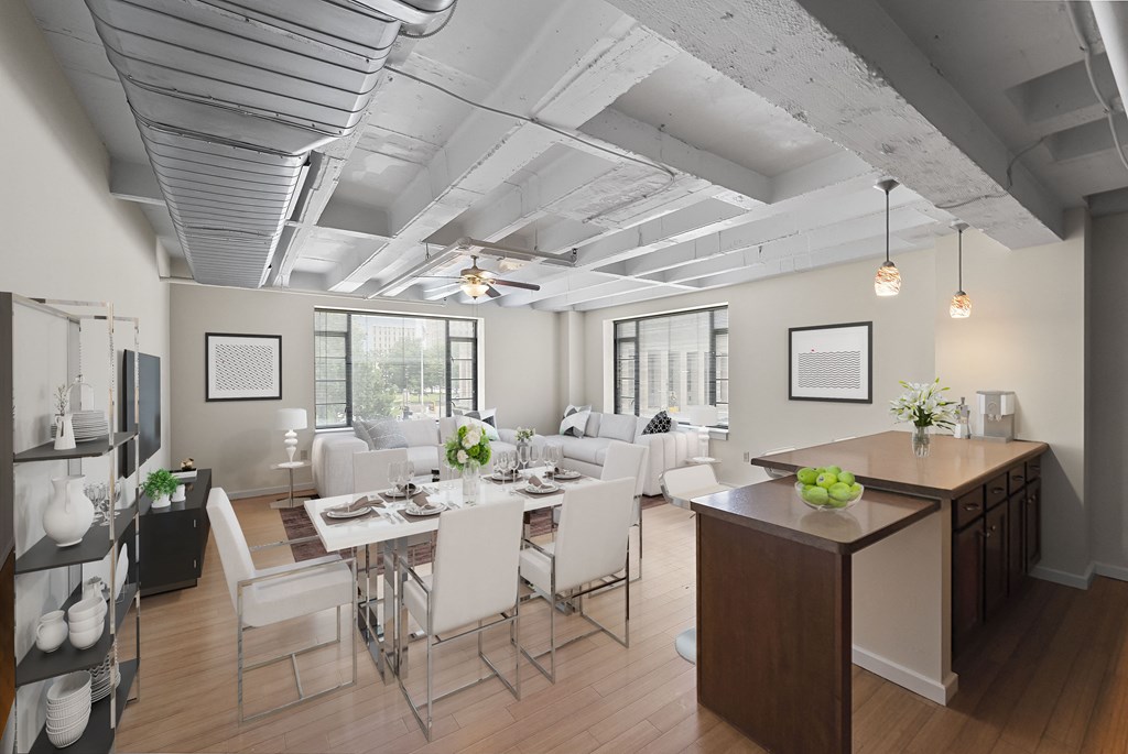 a living room and dining room with a table and chairs