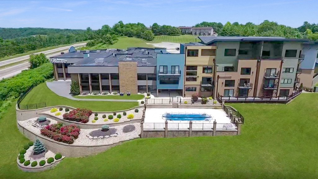 a rendering of a building with a pool and a yard