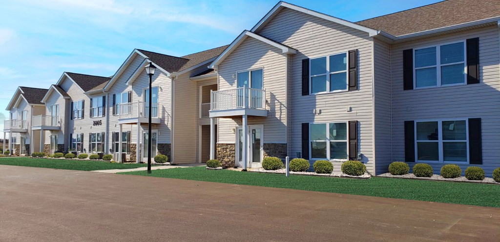 a row of houses with balconies and a driveway