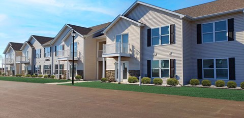 a row of houses with balconies and a driveway