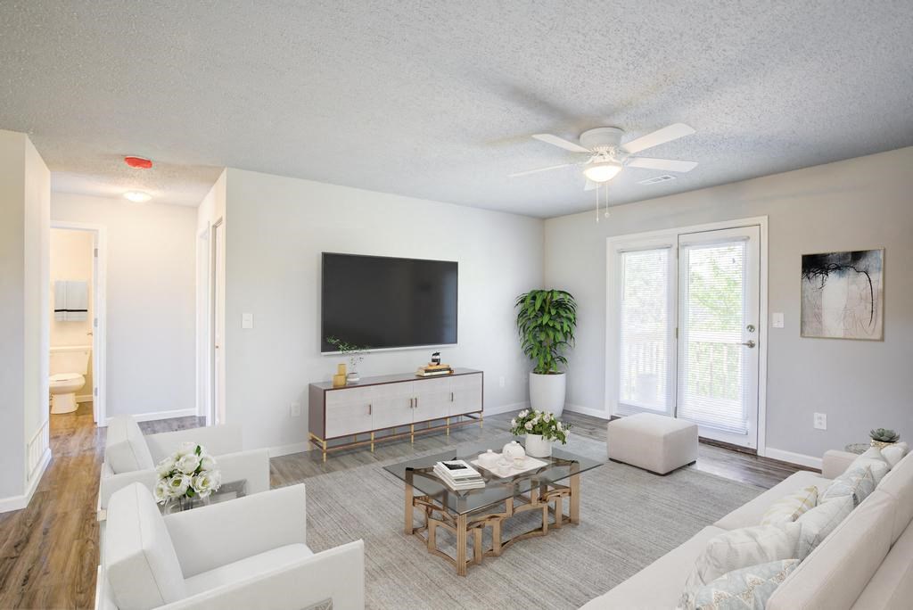 a living room filled with furniture and a flat screen tv