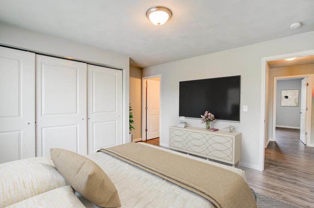 a bedroom with a large bed and a flat screen tv