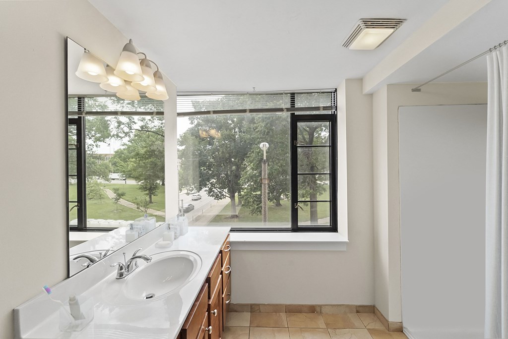 a bathroom with a sink and a large window