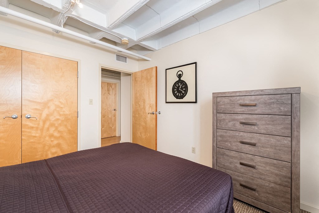 a bedroom with a bed and a closet