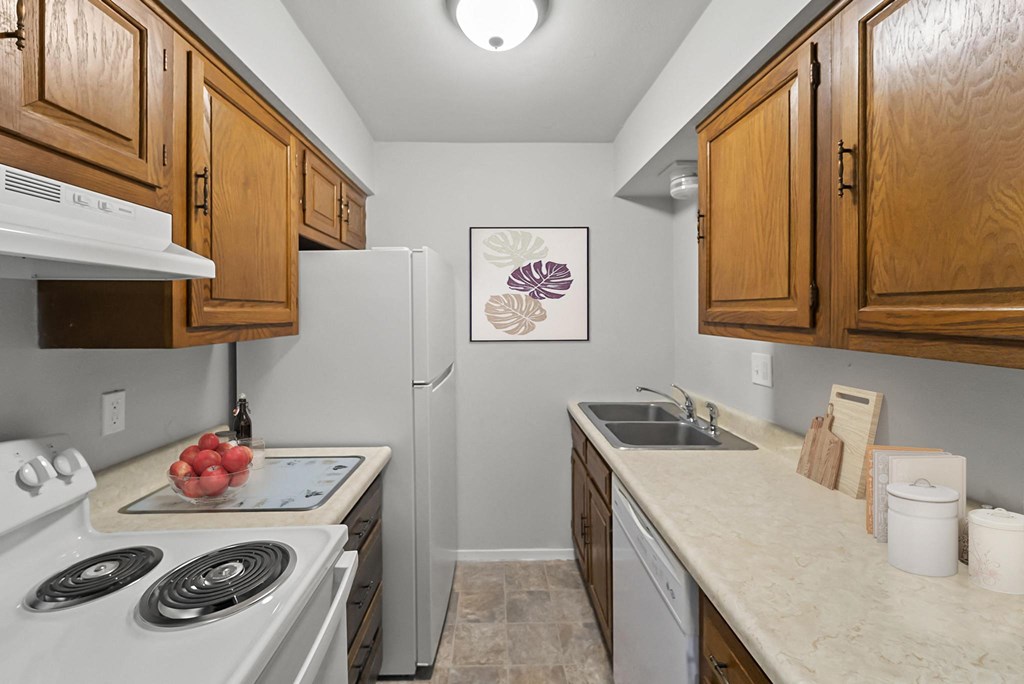 a kitchen with wooden cabinets and white appliances