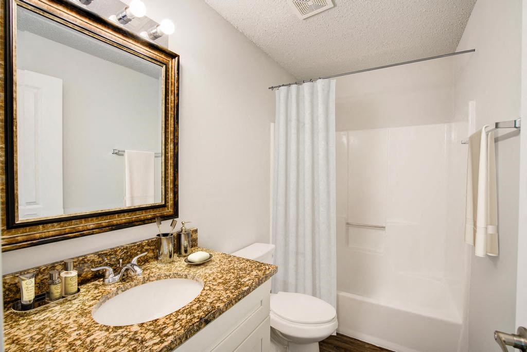 a bathroom with a sink toilet and shower