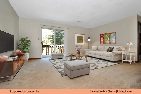 A living room with a white couch and a coffee table.