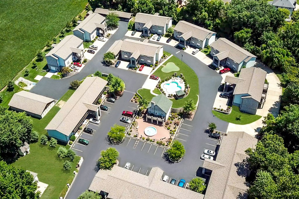an aerial view of a neighborhood with houses and a pool