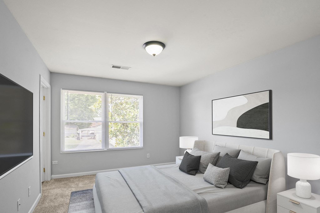 a bedroom with a large bed and a large window