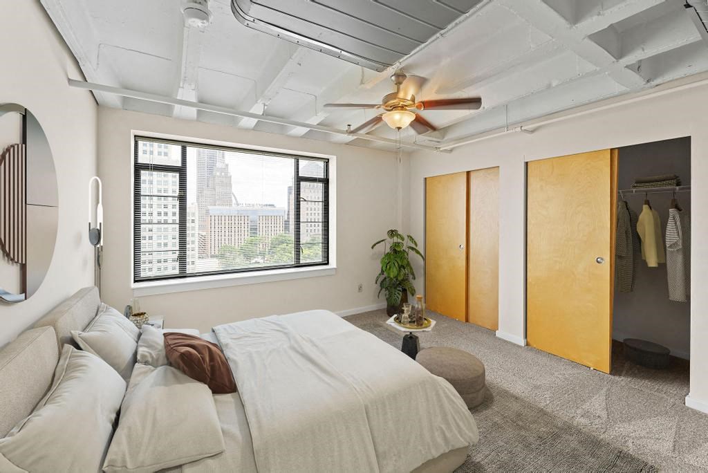 a bedroom with a bed and a ceiling fan