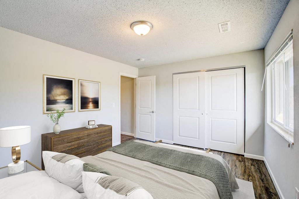 a bedroom with a bed and a dresser