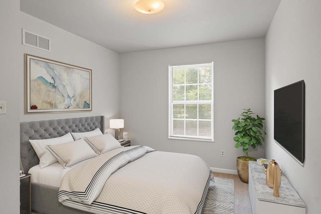 a bedroom with a large bed and a large window